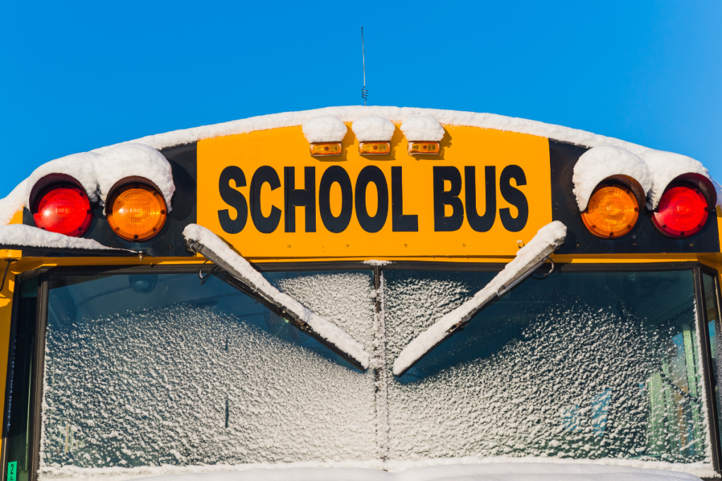 photo of school bus with a dusting of snow on it